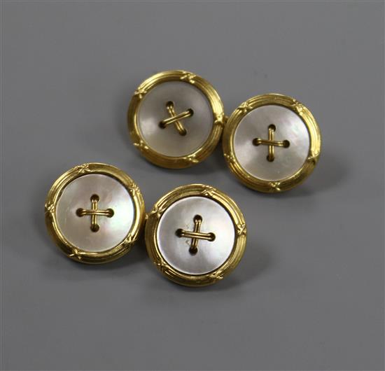 A pair of 18ct gold and mother of pearl dress cufflinks in the form of buttons.